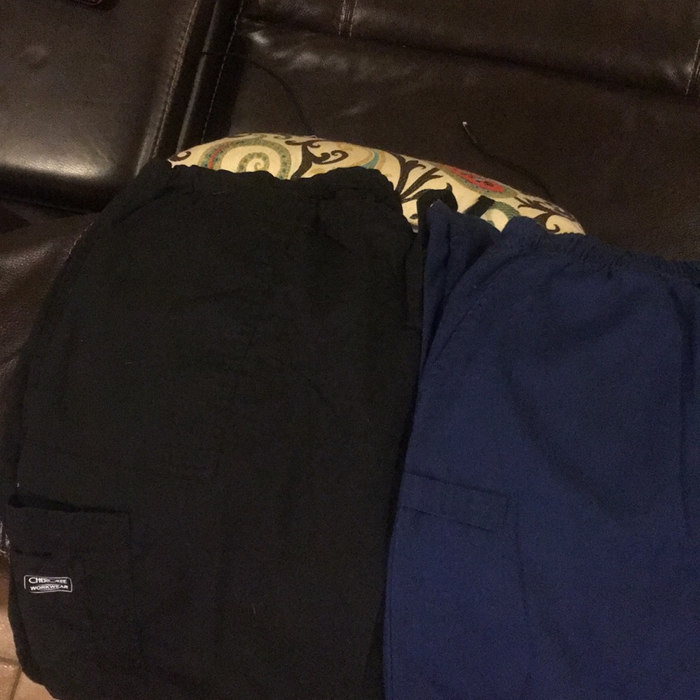 1 black and 1 blue pair of Cherokee scrubs.